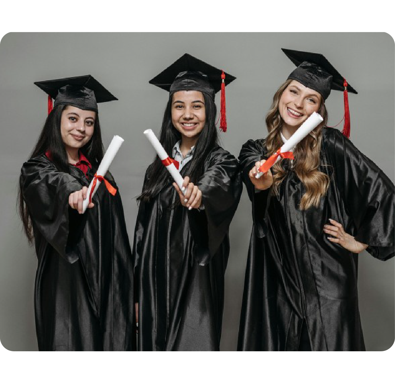 Person framing their face with their hands and wearing a graduation cap.