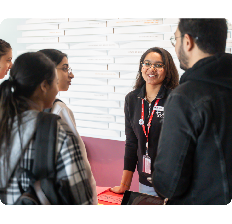Board member speaking with students at Mohawk.