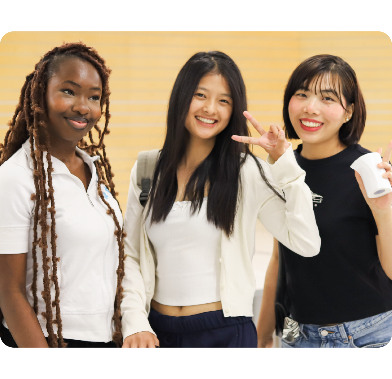Students smiling and holding up a peace sign.