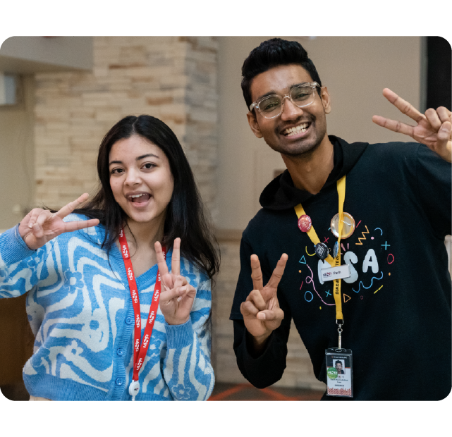 Students holding up peace signs.